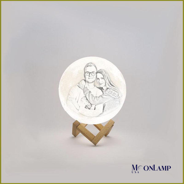 Image of couple engraved in small personalized moon lamp with wooden stand