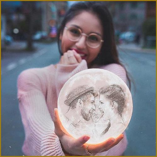 girl holding a 7 inch personalized lamp with image of a couple